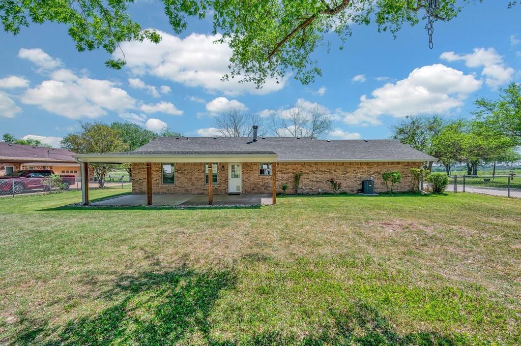 2857 Country Spring Road Lorena, TX 76655 - Photo 32 of 40 Rear view of house featuring brick siding, a patio area, and a shingled roof
