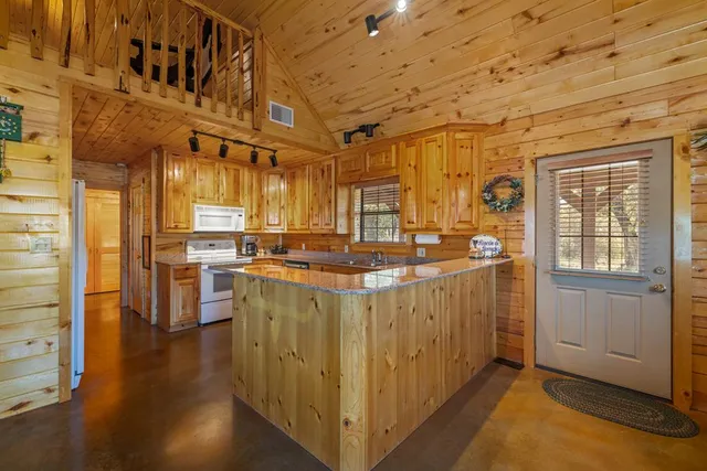 a kitchen with stainless steel appliances granite countertop a stove and cabinets