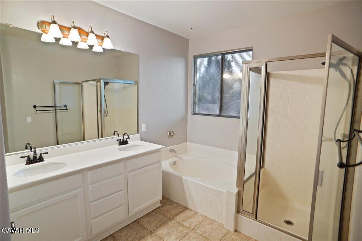 40308 Bolz Ranch Road Palmdale, CA 93551 - Photo 13 of 29 a bathroom with a double vanity sink mirror and bathtub
