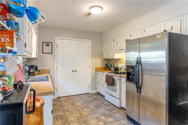 a kitchen with a refrigerator and a sink