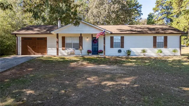 a front view of a house with a garden and patio