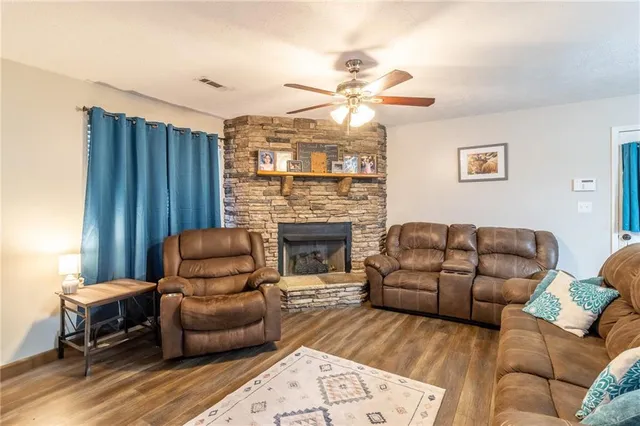 a living room with furniture a fireplace and a chandelier