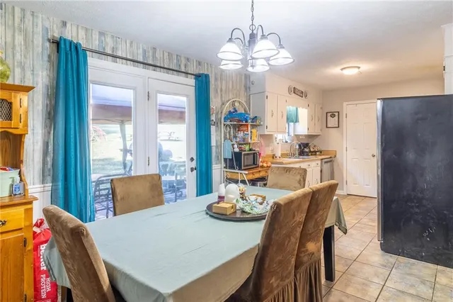 a view of a dining room with furniture and a chandelier