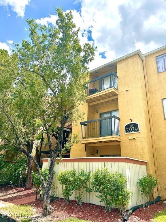 2929 Winkler Avenue, Unit 1018 Fort Myers, FL 33916 - Photo 1 of 34 a front view of a house with a yard