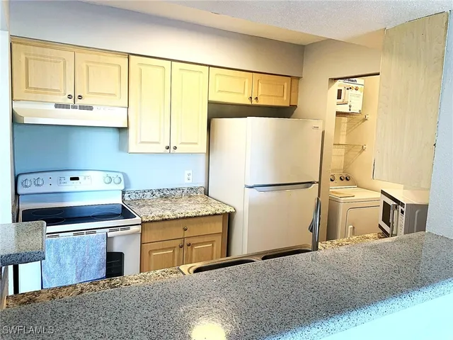 a kitchen with a stove and a refrigerator
