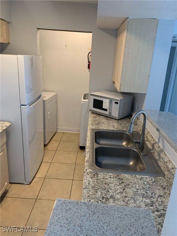 2929 Winkler Avenue, Unit 1018 Fort Myers, FL 33916 - Photo 13 of 34 a kitchen with a stove a refrigerator and washer