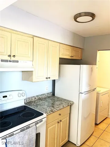 a kitchen with a sink a stove and a refrigerator
