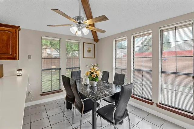 a dining room with furniture a chandelier and window