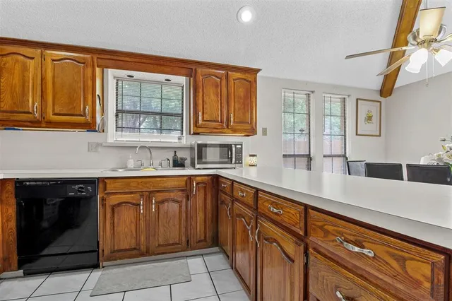 a kitchen with stainless steel appliances granite countertop a sink and cabinets