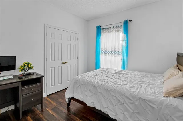 a bedroom with a bed and a table in it