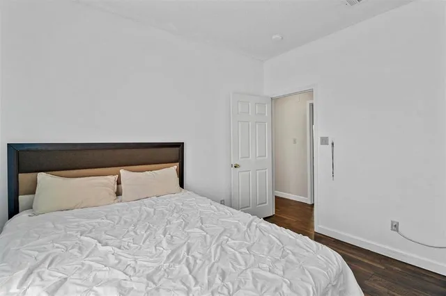 a bedroom with a bed and a night stand