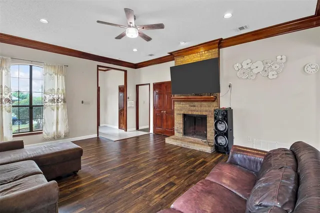 a living room with furniture a fireplace and a flat screen tv