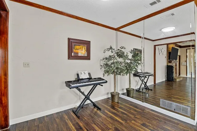 a work room with furniture and wooden floor