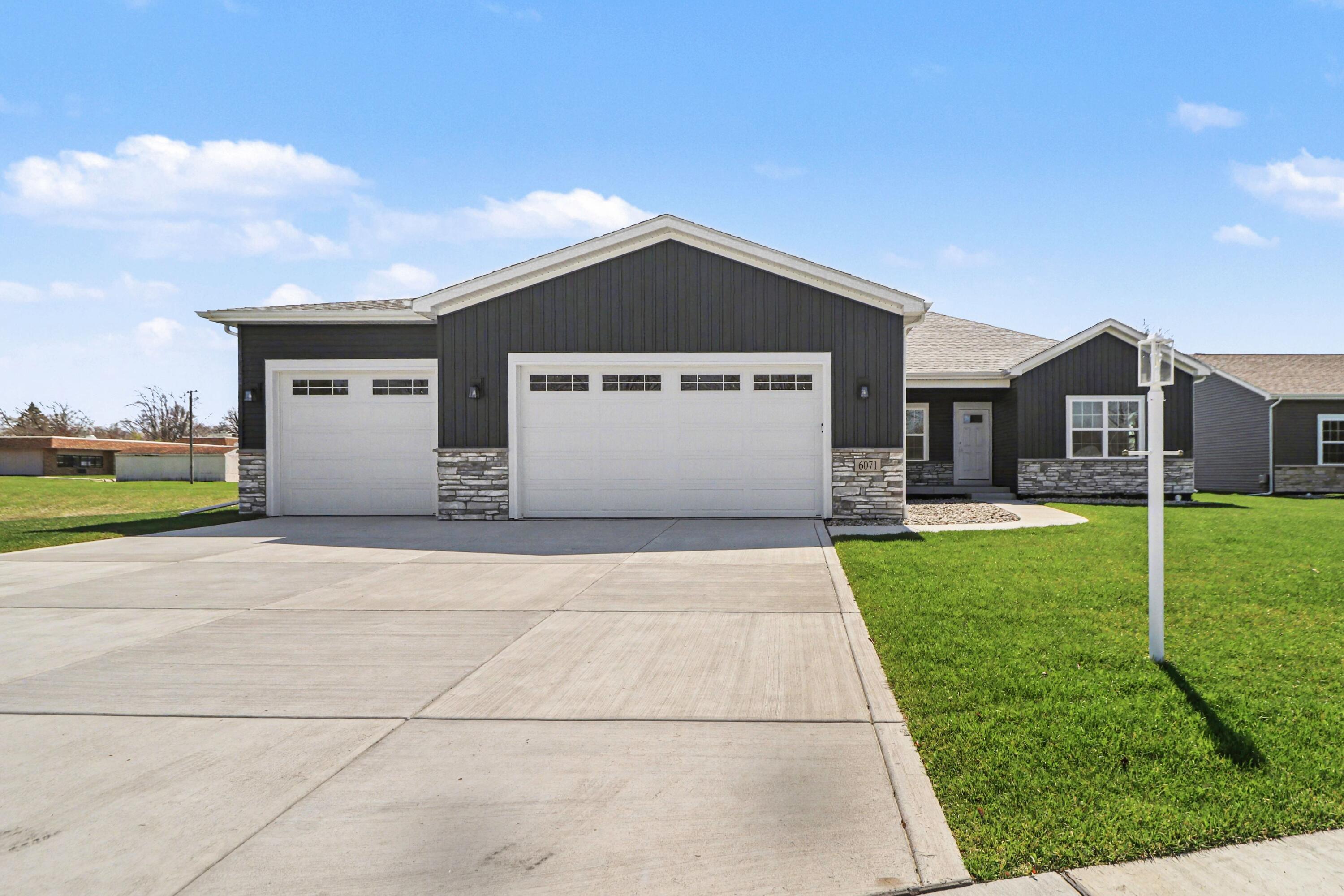 6071 Robbins Road Portage, IN 46368 - Photo 1 of 14 a front view of a house with a yard and garage