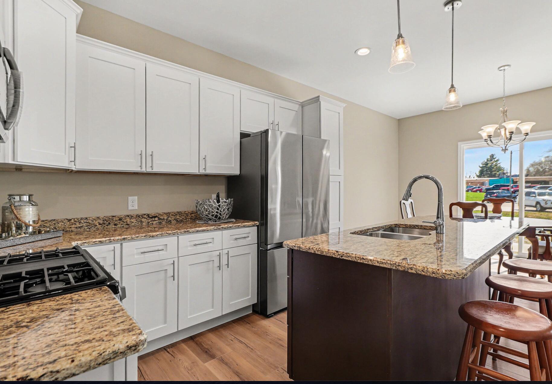 6071 Robbins Road Portage, IN 46368 - Photo 5 of 14 a kitchen with stainless steel appliances granite countertop a sink stove and refrigerator