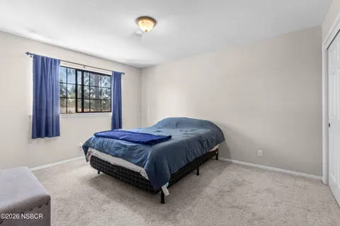 a spacious bedroom with a bed and window