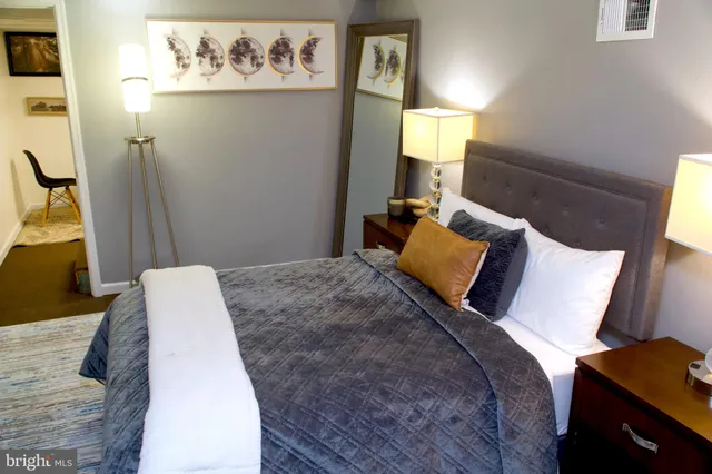 a bed sitting in a bedroom next to a window