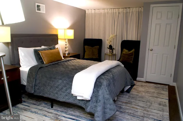 a bed room with a bed chair and a window