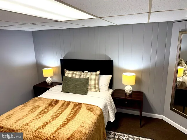 a bed sitting in a bedroom next to a lamp next to a lamp