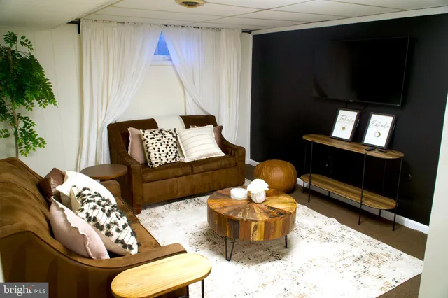 a living room with furniture rug and wooden floor