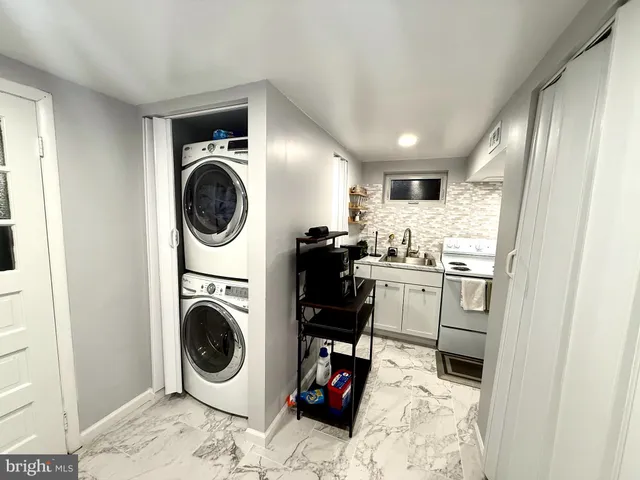 a kitchen with a refrigerator sink and cabinets
