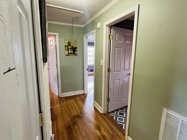 a view of a hallway with wooden floor