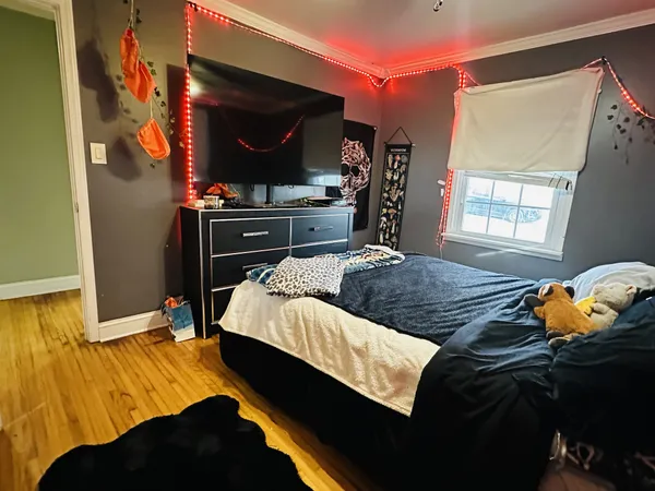 a bedroom with a bed and a flat screen tv