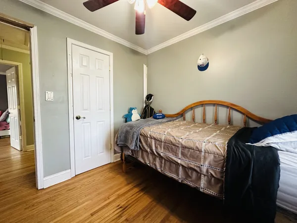 a bedroom with a bed and a chandelier