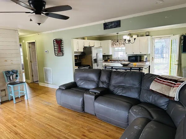 a living room with furniture and a wooden floor