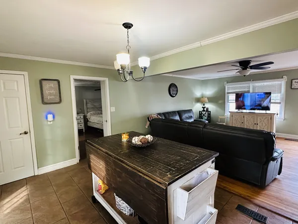 a living room with furniture and a chandelier