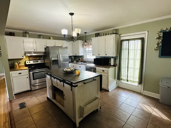 a kitchen with a stove a sink and a refrigerator