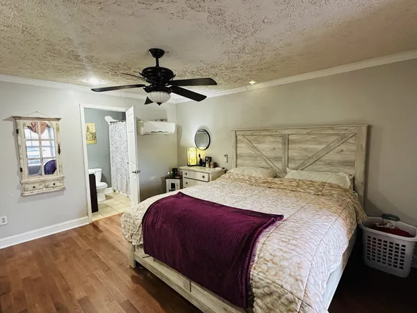 a bedroom with a bed and wooden floor