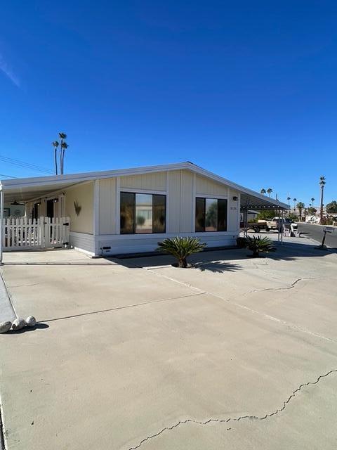 a front view of a building with cars parked