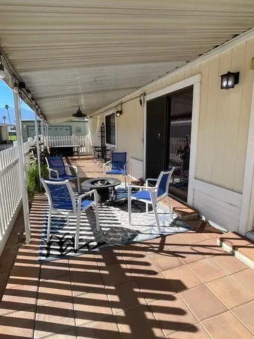 a view of a patio with table and chairs a barbeque with wooden floor