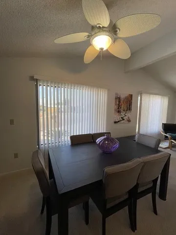 a view of a dining room with furniture and chandelier