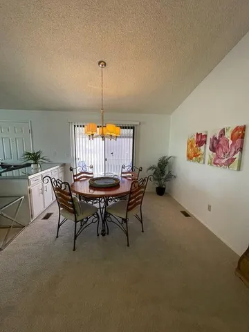 a dining room with furniture and window