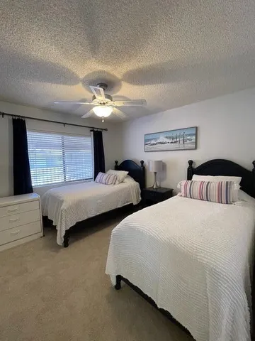 a bedroom with two beds and a couch