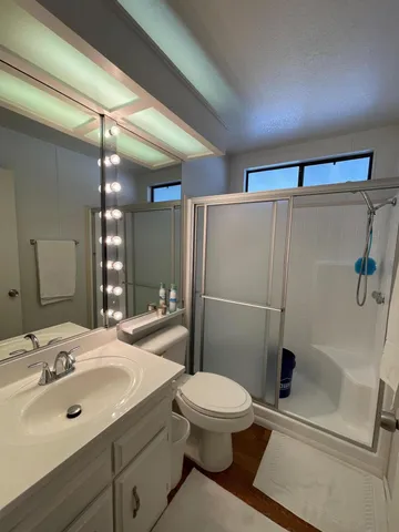 a bathroom with a sink toilet and shower