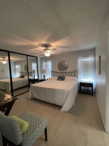 a spacious bedroom with a bed and window