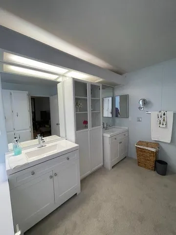 a living room with furniture and a refrigerator