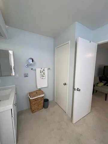 a spacious bathroom with a double vanity sink and a mirror