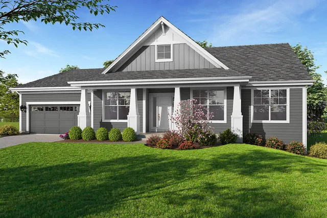 a front view of a house with a yard and garden