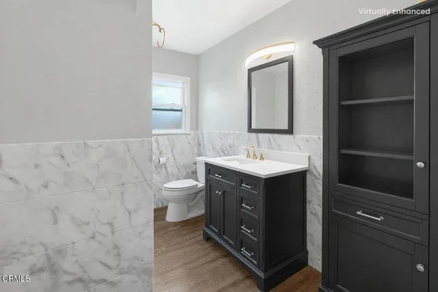 a bathroom with a double vanity sink mirror and toilet
