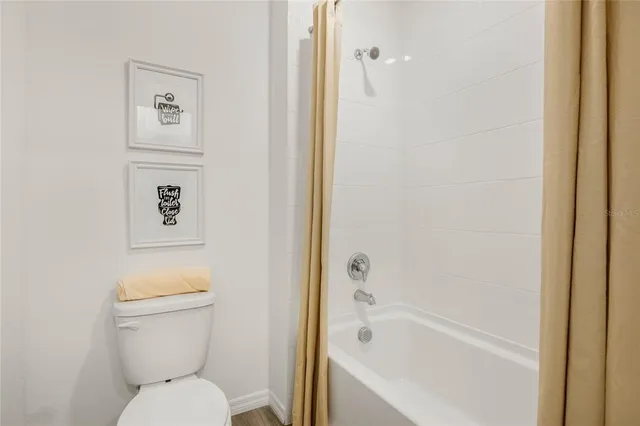 a living room with furniture and large windows