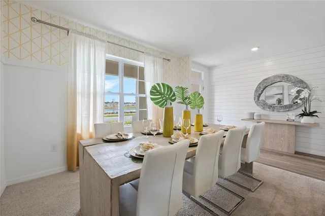 a kitchen with stainless steel appliances granite countertop a sink a stove a refrigerator cabinets and chairs