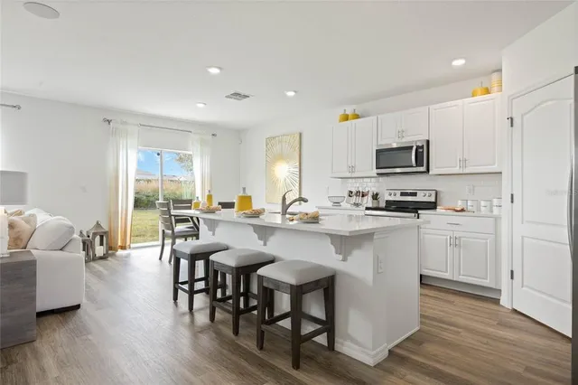 a kitchen with a sink cabinets and stainless steel appliances