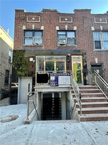 a view of a brick building with a window and balcony