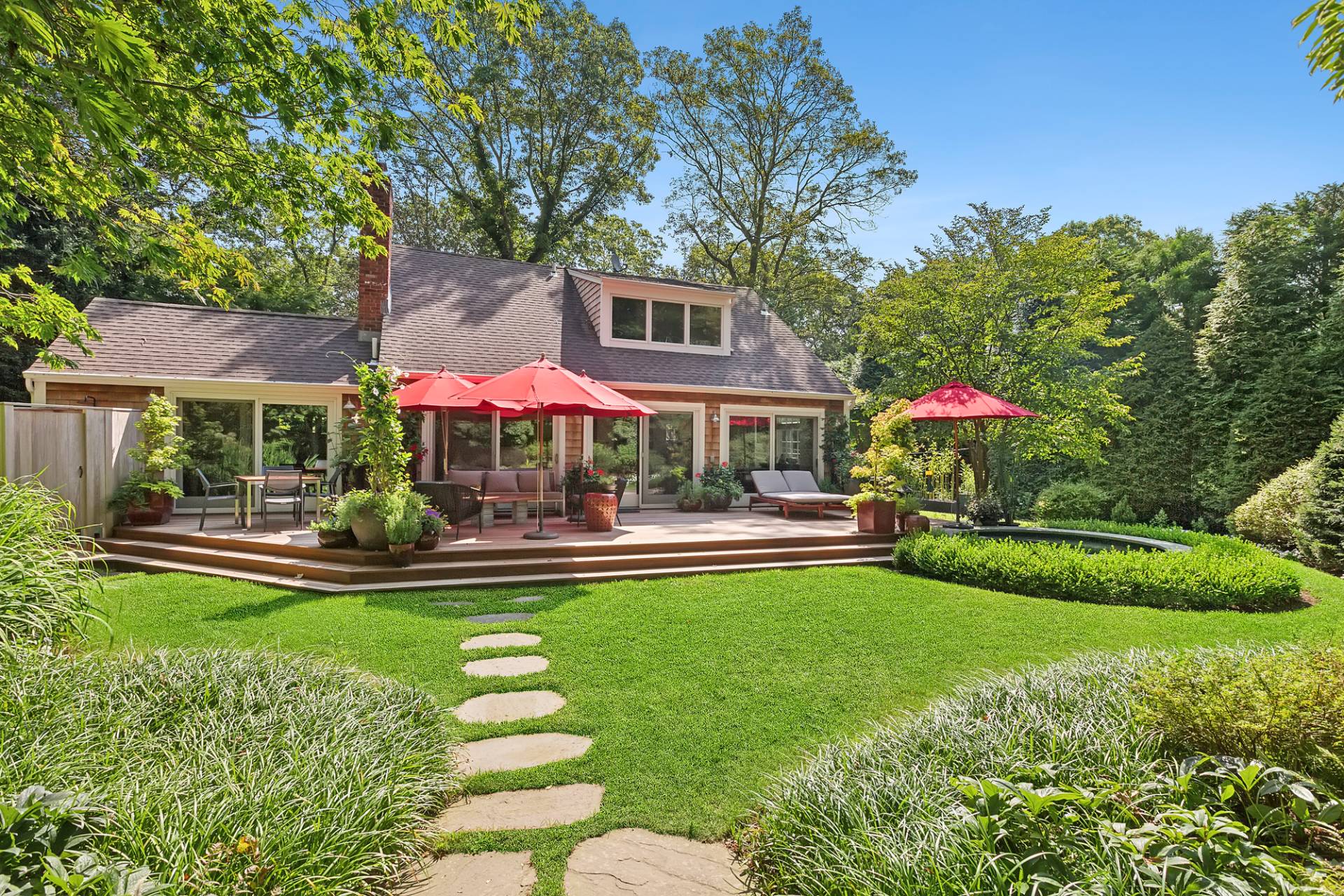 229 Water Mill Towd Road Water Mill, NY 11976 - Photo 3 of 35 a front view of a house with swimming pool having outdoor seating