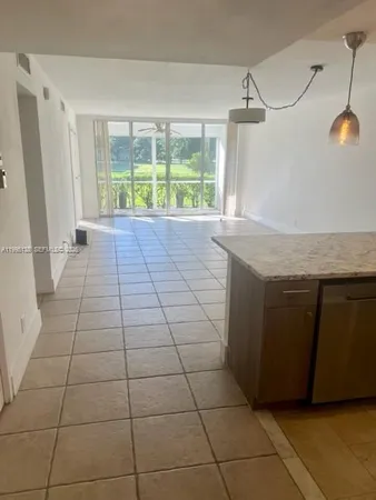 a kitchen with a sink a window and a counter top space