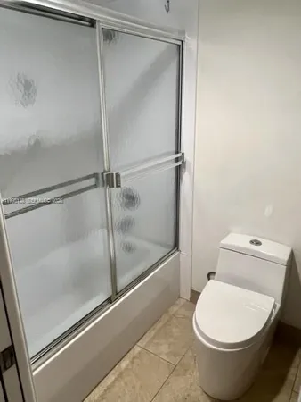 a bathroom with a toilet and a shower